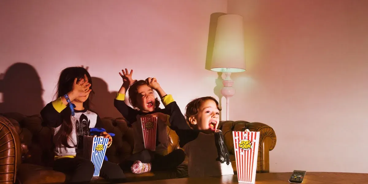 Two girls watching movies in the dark