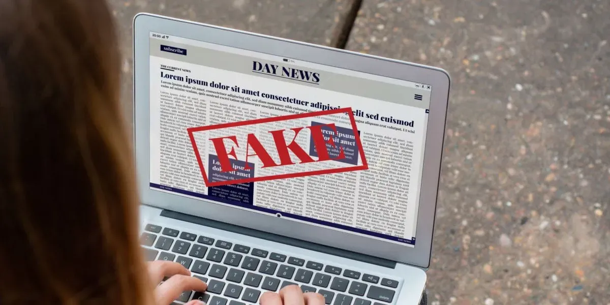 Teenager reading fake News on laptop