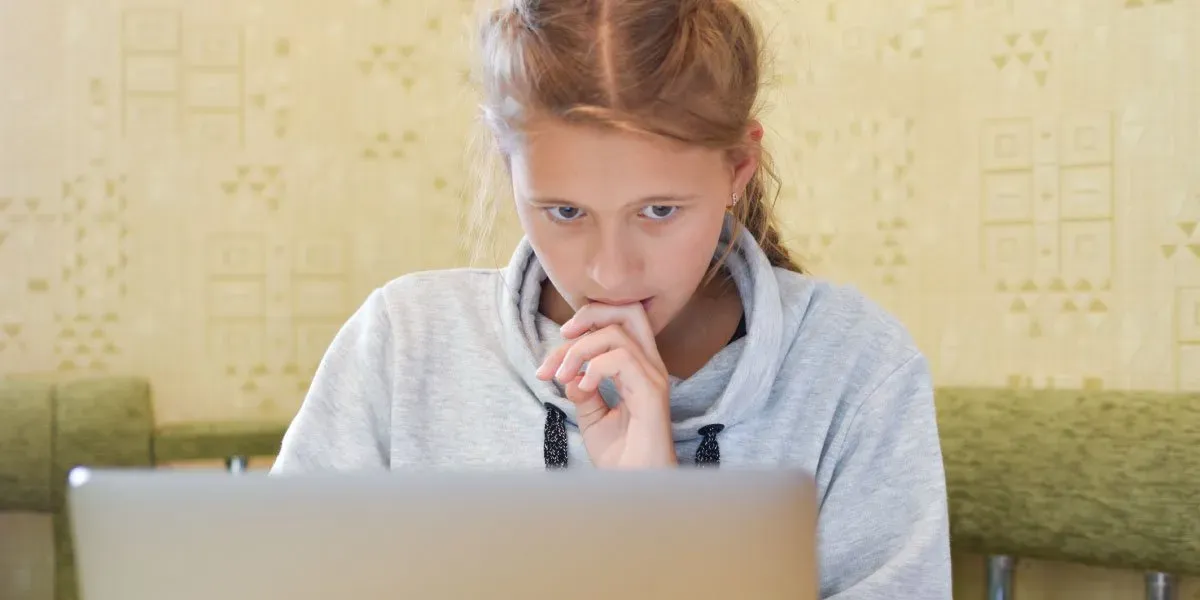 Anxious girl chatting online on a laptop