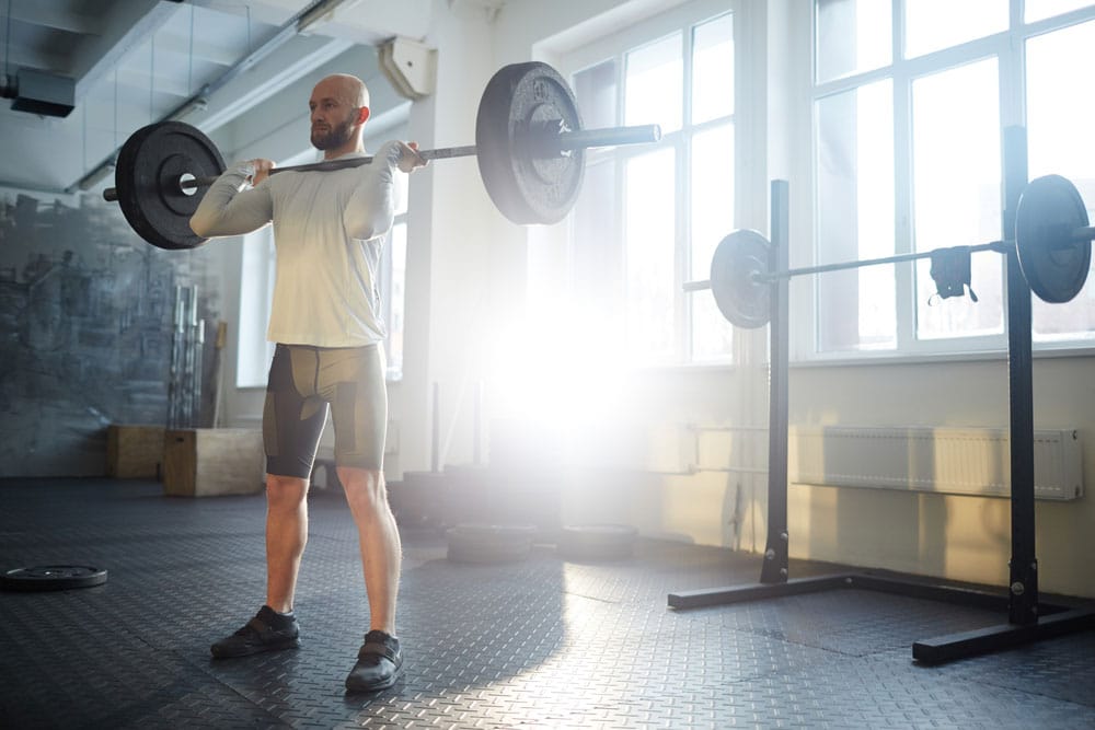 A man doing deadlifts with heavy weights