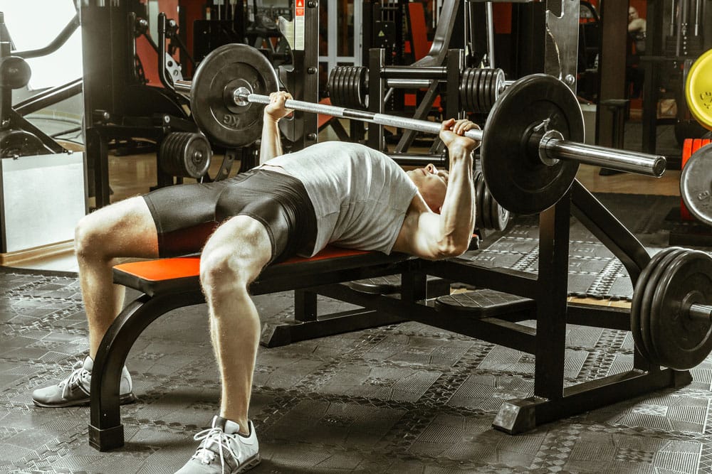 A man with improved performance on bench press due to warm-up