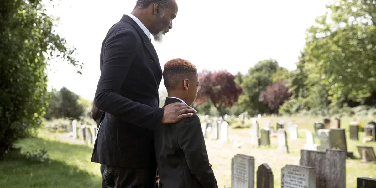 Family visiting grave of loved one